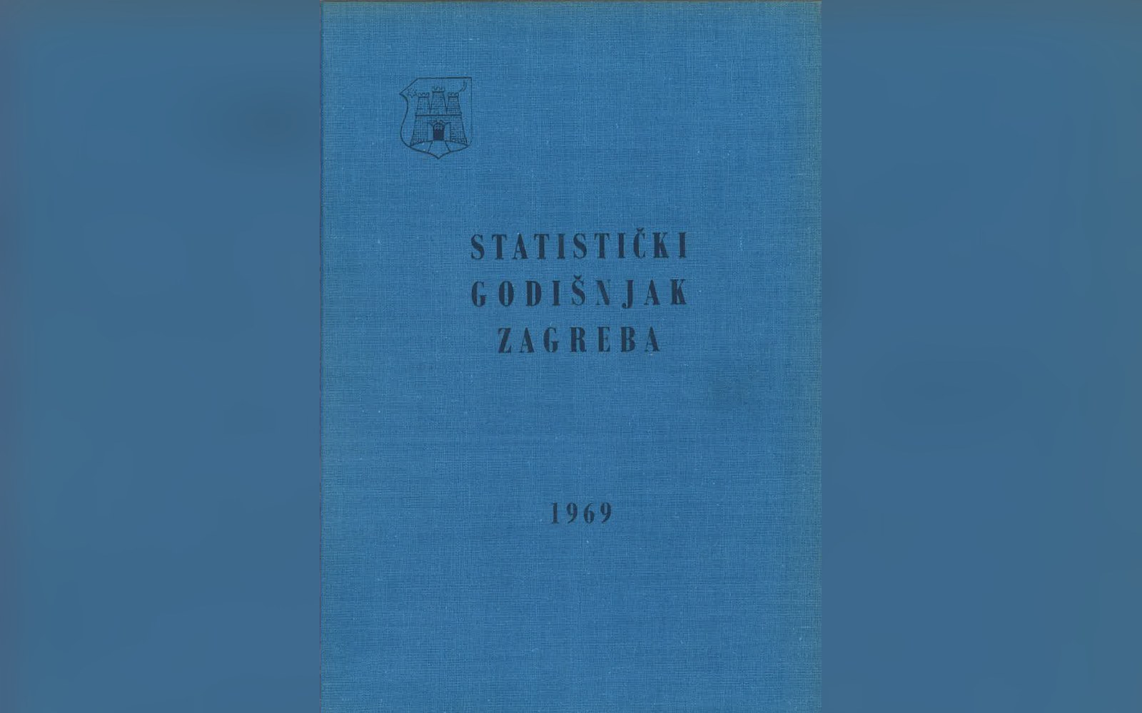 A printed statistical yearbook open on a table with a pencil