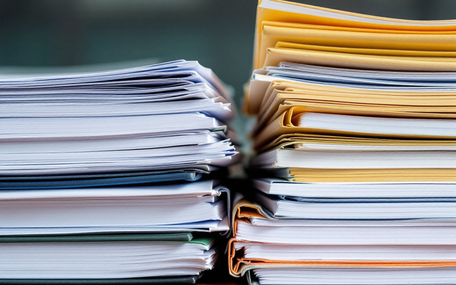 Two stacks of differently formatted reports side by side